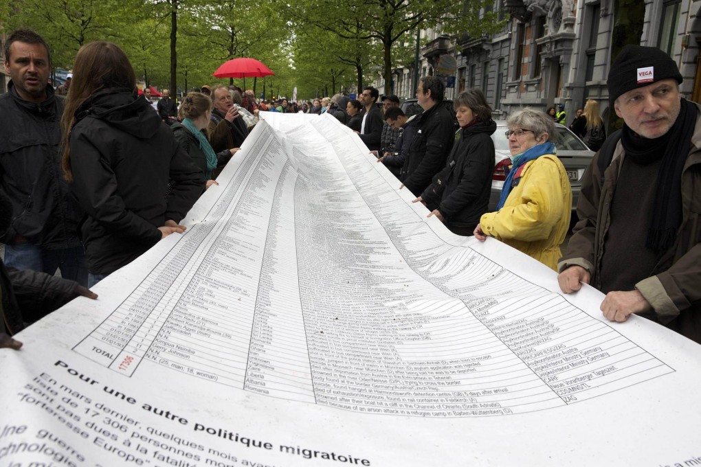 List of names of dead migrants in a protest march.Photo: AFP