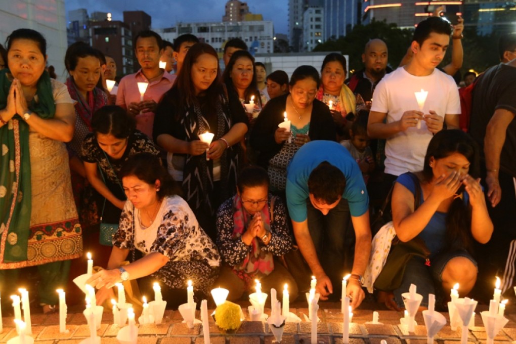 Nepalese attend Candle Light Vigil to pay respects to victims of the earthquake in Nepal. Photo: Sam Tsang