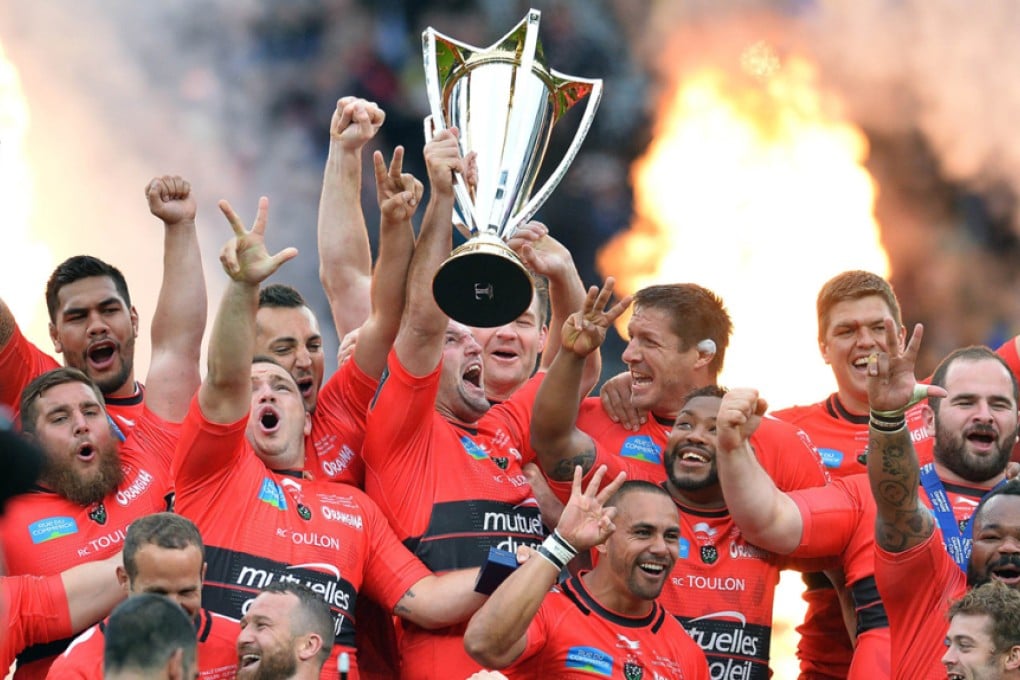 The triumphant Toulon players celebrate with the silverware after beating Clermont 24-18 on Saturday to capture their third successive European Rugby Champions Cup. Photos: AFP
