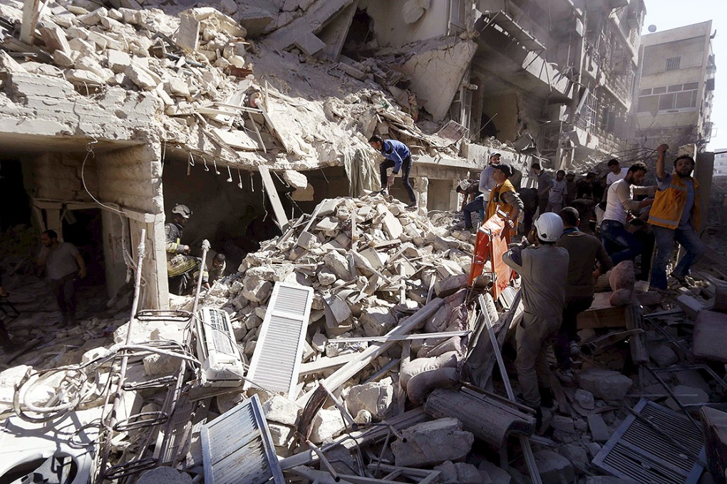 Residents and civil defence members search for survivors at a damaged site after what activists said was a barrel bomb dropped by forces loyal to Syria's President Bashar al-Assad and hit a school and a residential building. Photo: Reuters
