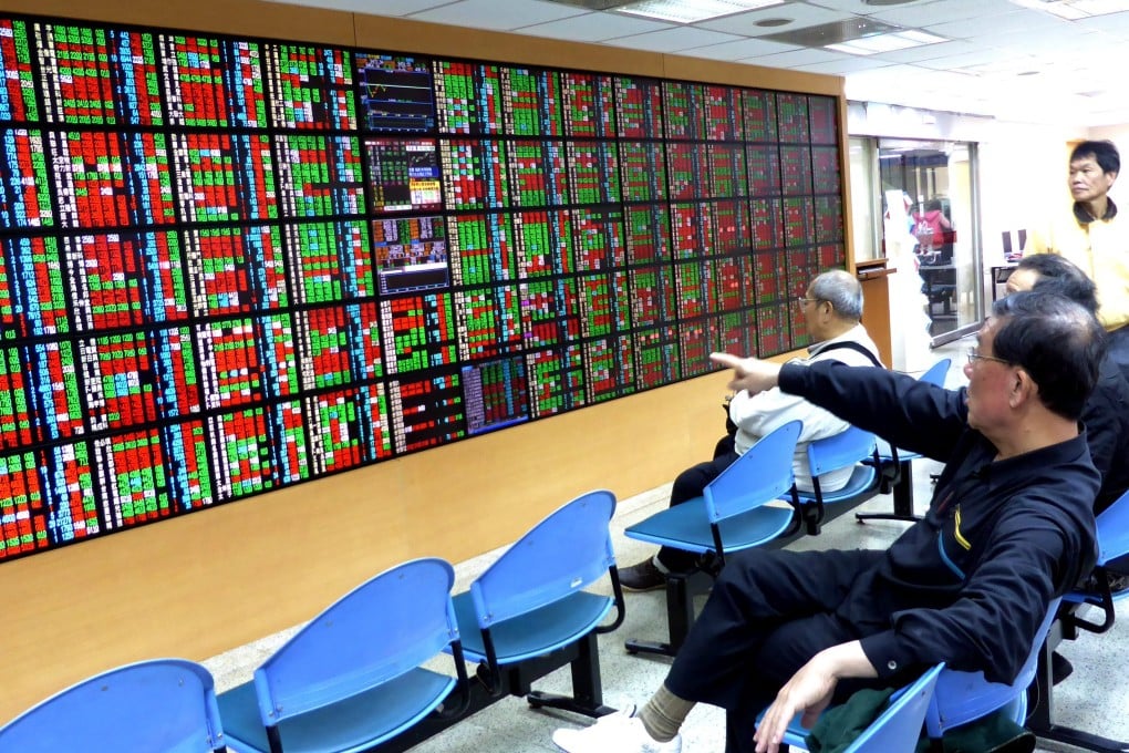 An investor watches prices of shares on the Taiwan Stock Exchange at a brokerage in Taipei. The Taiwan bourse is described in a report as a 'stealth bull market.' Photo: EPA
