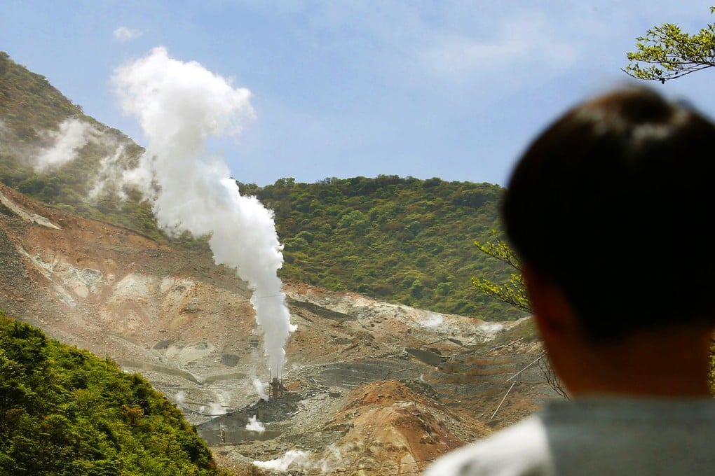 A tourist watches steam bursts in the Owakudani hot spring district of Mt Hakone. Photo: Kyodo