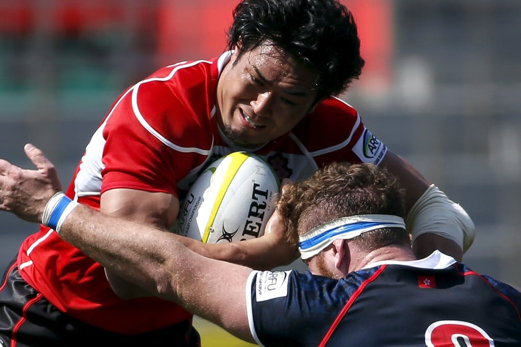 Alexander Harris tries to stop Japan's Shoji Ijo. Photo: Reuters