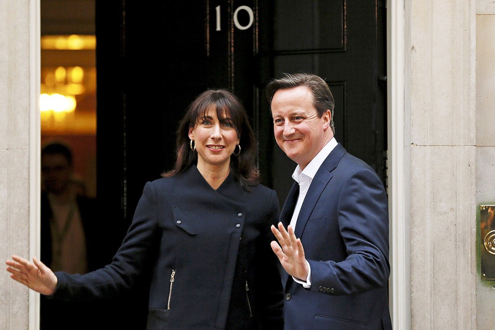 Britain's Prime Minister David Cameron and his wife Samantha wave as they arrive at Number 10 Downing Street in London. Photo: Reuters