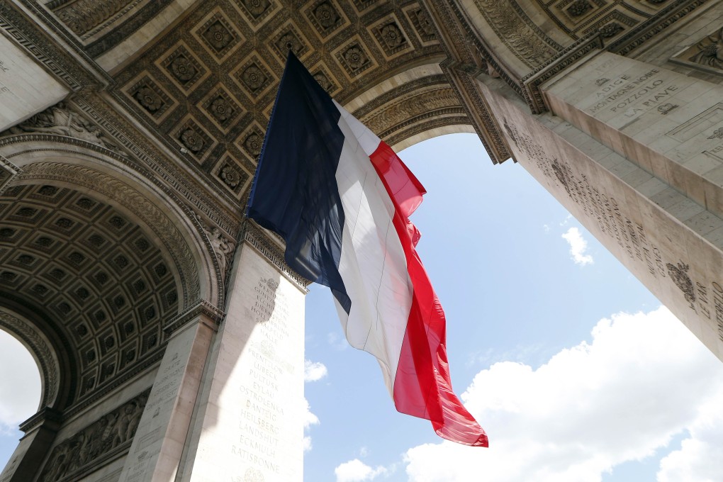 A French flag hangs under the Arc de Triomphe monument in Paris in preparation for Europe Day celebrations. Photo: AFP