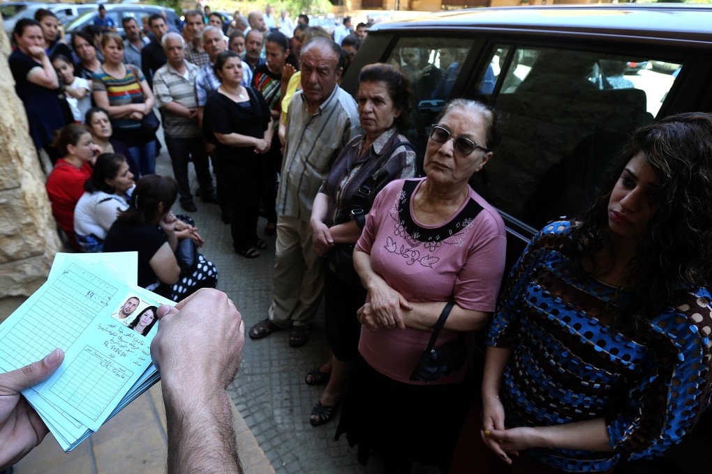 Iraqi Christians who fled the violence in Iraq between government forces and Islamic State militants wait to receive aid in Lebanon. Photo: AFP