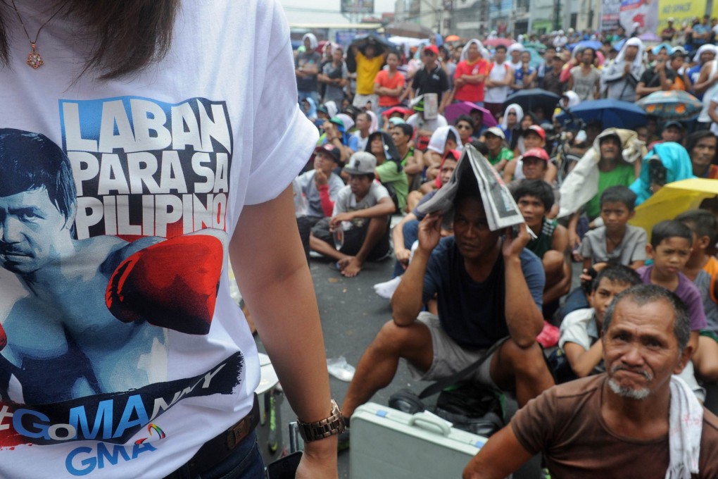 Fans in Manila watch a live telecast of the Manny Pacquiao and Floyd Mayweather Jnr fight in Las Vegas. Millions of fans in the Philippines shouted and groaned in disappointment on May 3 as their national hero lost. Photos: AFP
