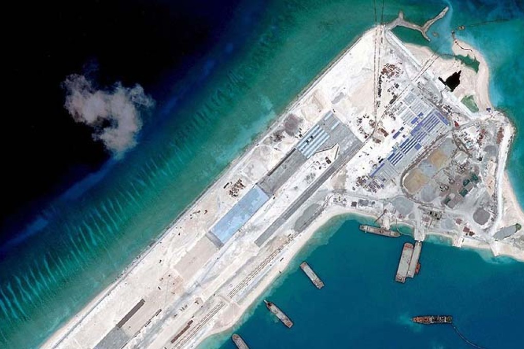 A handout photo taken on April 2 by satellite image provider DigitalGlobe shows what is claimed to be an airstrip at Fiery Cross Reef in the Spratly Islands under construction by China. Photo: AFP