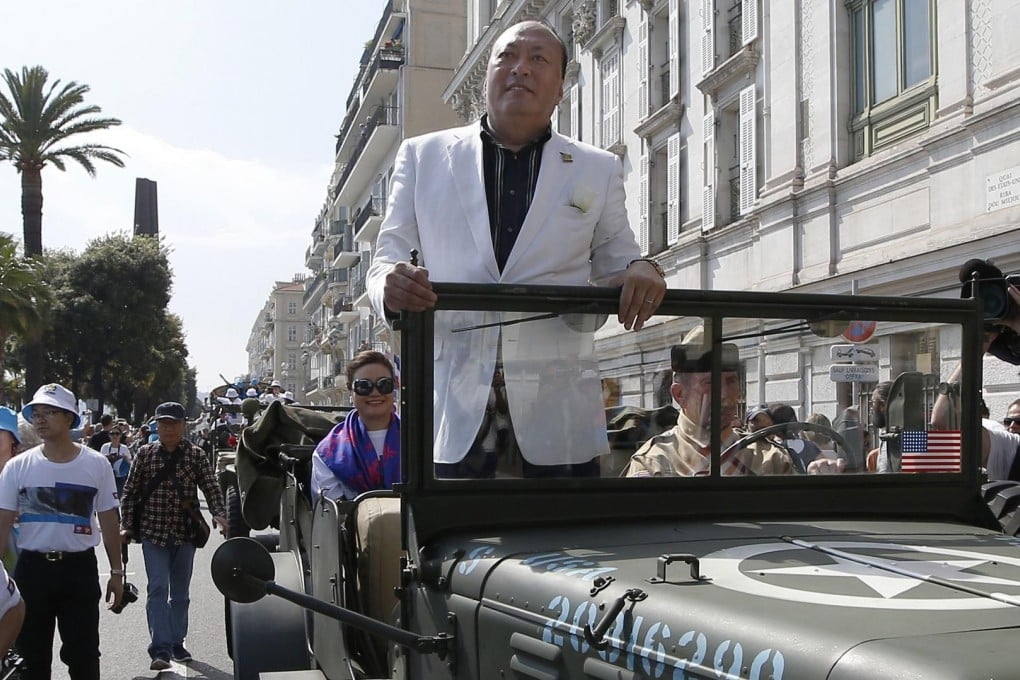 Li Jinyuan is driven down a street in Nice during a parade marking the anniversary of the end of the second world war in Europe. Photo: AFP