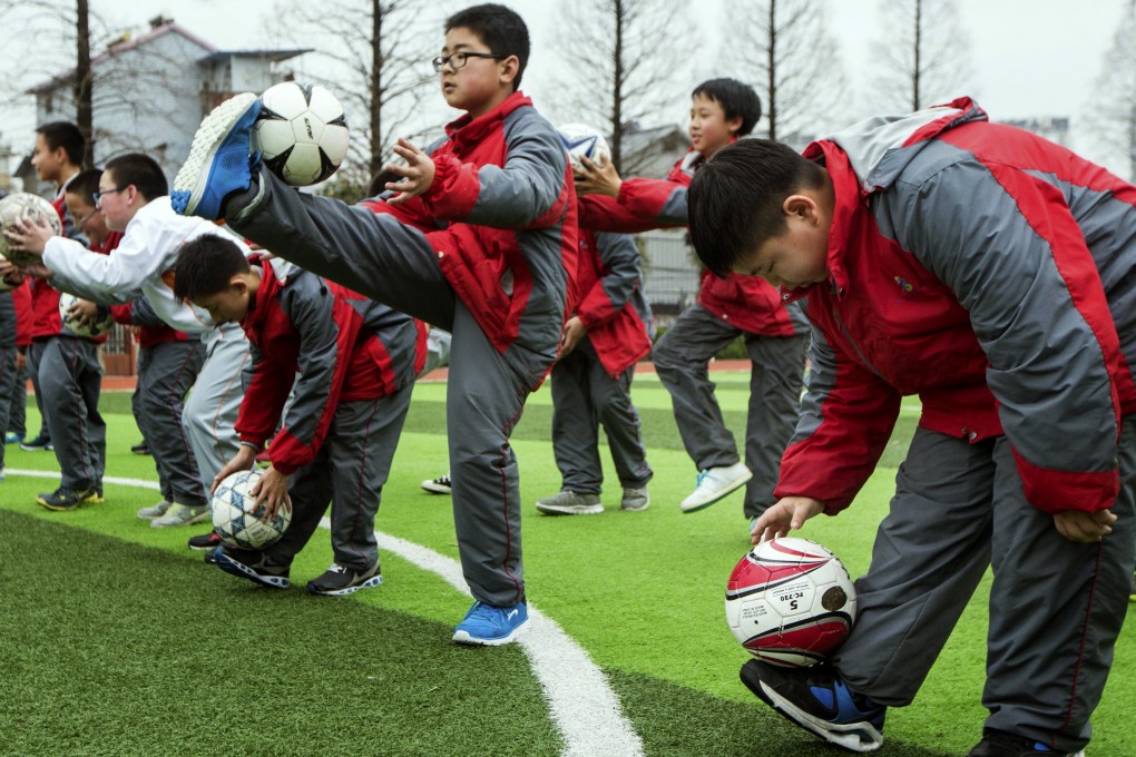 Middle School students in a soccer class in Hangzhou in the eastern province of Zhejiang. With backing from the country's most powerful football fan, Chinese President Xi Jinping, the government is investing in the long-term development of the sport. Photos: AP