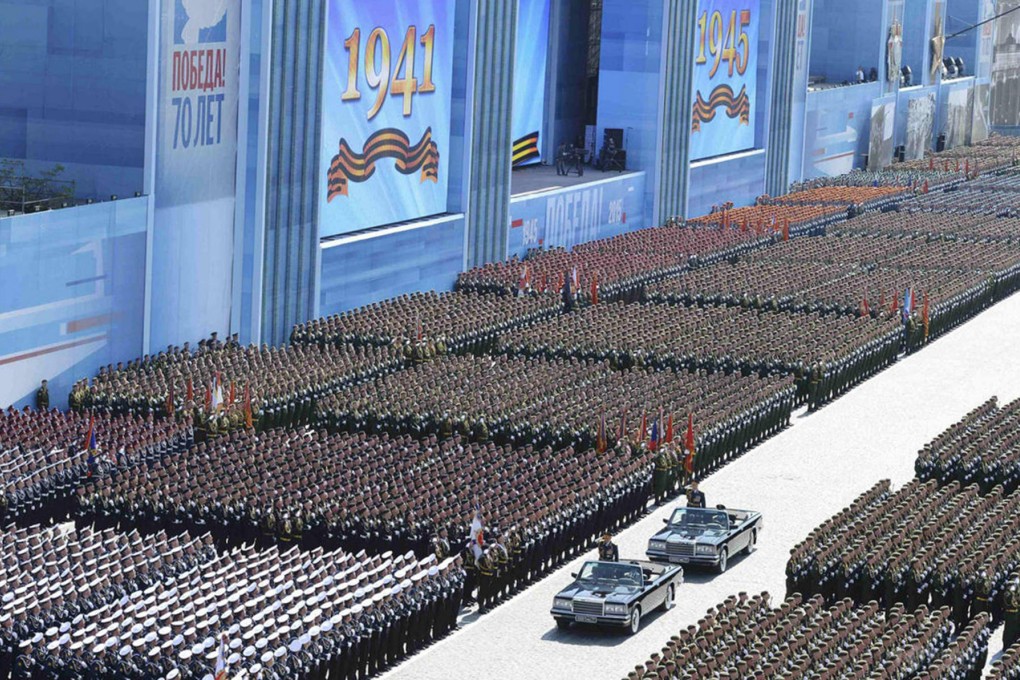 Russian defence minister Sergei Shoigu, in first car, and army commander Oleg Salyukov, behind, salute the victory parade in Red Square yesterday. Photo: SCMP
