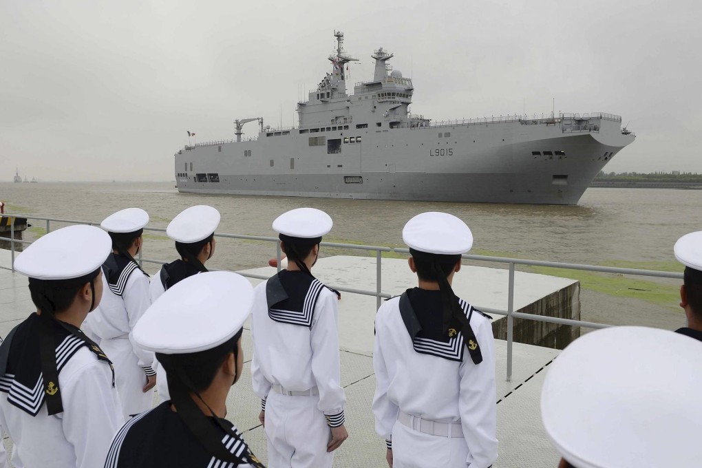 Members of the PLA Navy watch France's Dixmude arrive at Shanghai yesterday. Photo: Reuters