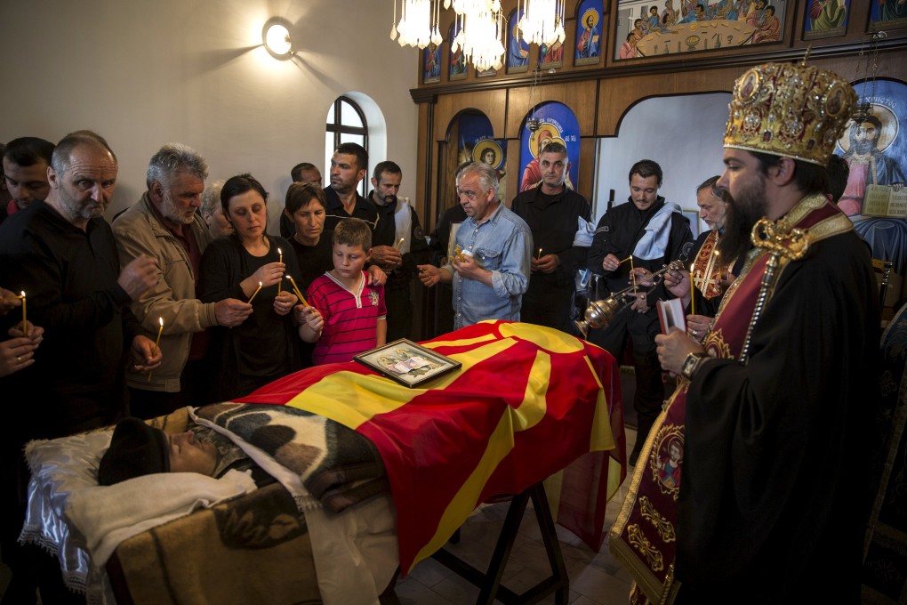 Relatives of Zarko Kuzmanovski, a Macedonian police special forces member, mourn at his funeral in the village of Brvenica on Sunday, after he was killed in the weekend attack in Kumanova. Photo: Reuters