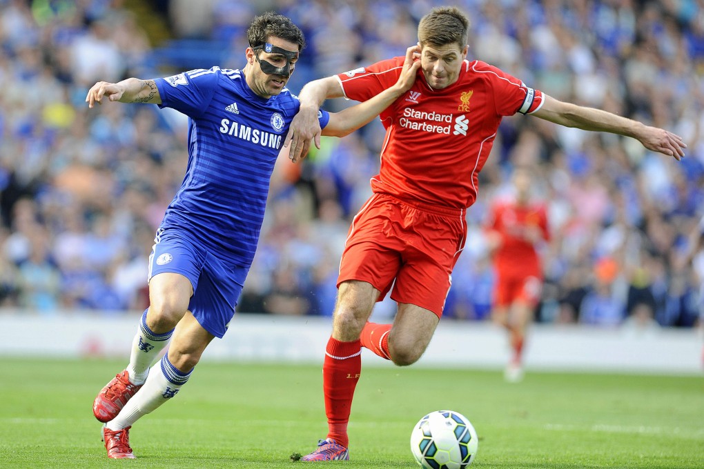 Cesc Fabregas tussles with Steven Gerrard. Photo: AP