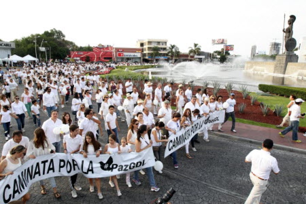 People participate in a march for peace in Mexico after violent actions by alleged members of the Cartel Jalisco New Generation, in Guadalajara, Mexico. Photo: EPA