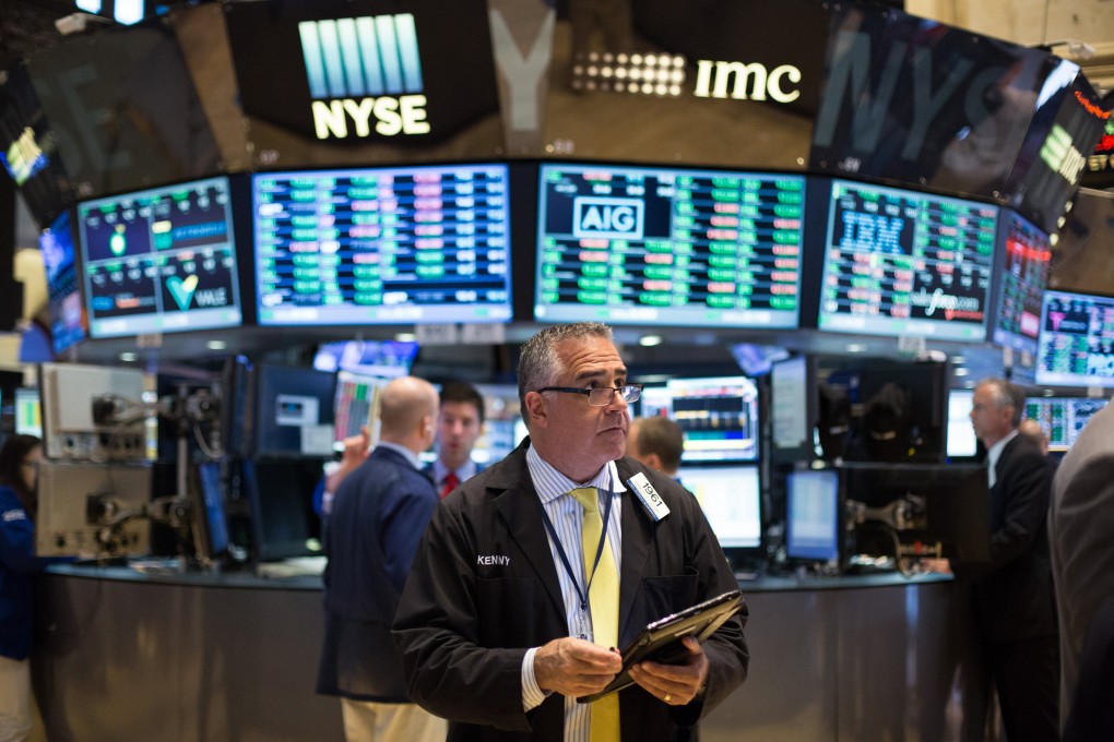 Floor traders scurry around the New York stock market on Friday after a strong jobs report and a surprise win in the UK by the Conservative Party sparked an advance in financial markets. Photo: AP