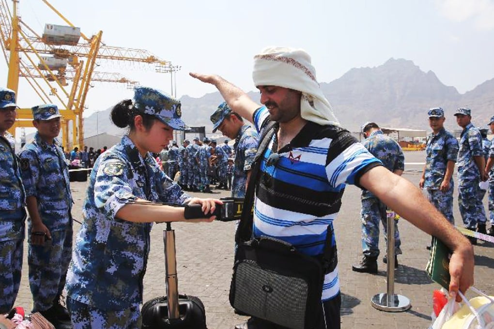 A crew member of the PLA frigate Linyi searches an evacuee in Aden, Yemen last month. The ship and two other Chinese warships have sailed to the Mediterranean Sea for joint exercises with the Russian Navy. Photo: SCMP Pictures