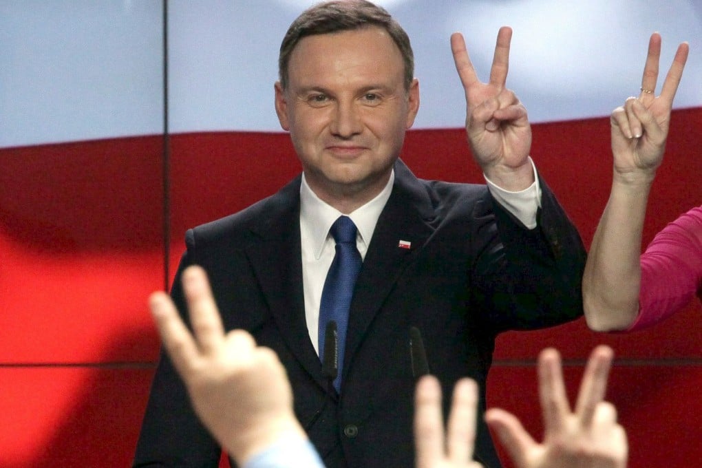 Andrzej Duda, candidate of the conservative opposition Law and Justice party, shows a victory sign after the announcement of the first exit polls in the first round of the Polish presidential elections on Sunday. Photo: Reuters