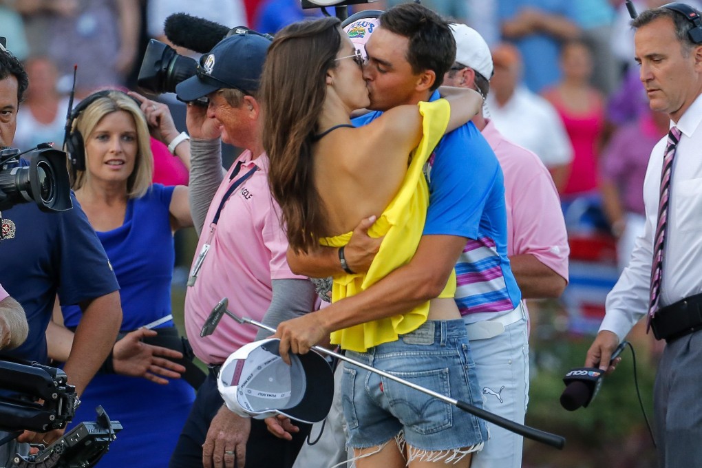 Rickie Fowler kisses his girlfriend, Alexis Randock, after winning the play-off at The Players Championship at the TPC Sawgrass in Ponte Vedra Beach, Florida. Photo: EPA