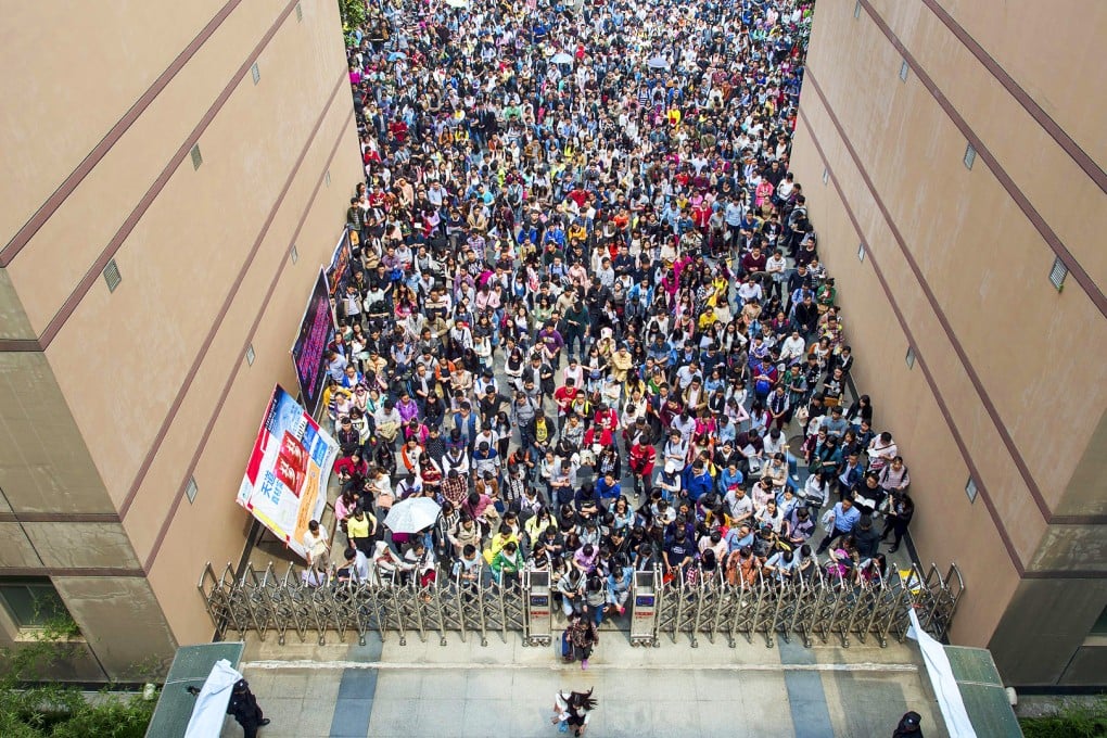 Hundreds of people queue up to take part in a civil servants entrance exam in Wuhan in central China last month. Suqian's mayor said officials in his area were responsible for 569 types of licence, permits and vocational qualifications. Photo: Reuters