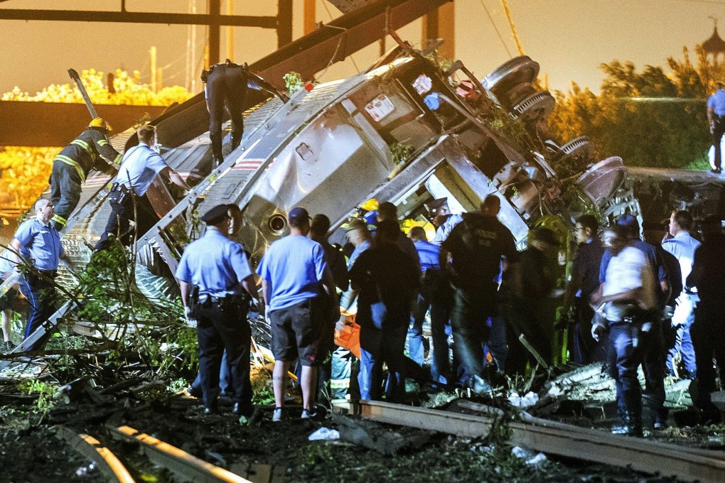 Rescuers climb into the wreckage of the Amtrak train, which crashed in Philadelphia with more than 200 passengers on board. Photo: Reuters
