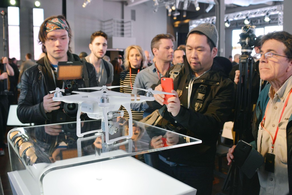 New Yorkers admire a DJI drone. Hundreds of Chinese start-ups are looking to emulate DJI's global success with drones of their own. Photo: Kyodo
