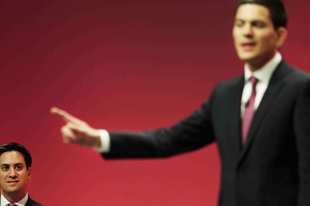 Ed Miliband (left) listens as his brother, David, delivers an address at the Labour Party's 2007 conference. Photo: AP