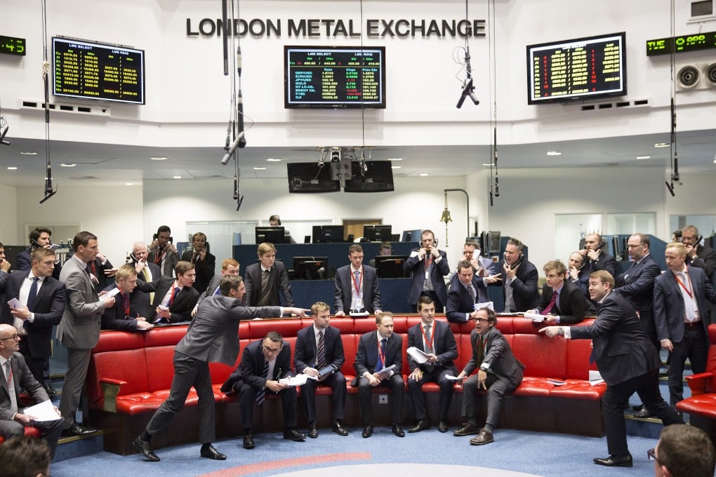 Metal dealers trade on the London Metal Exchange as analysts fear a prolonged downturn in China's property sector may eventually hit prices of copper. Photo: Bloomberg
