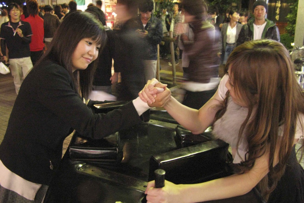 Gripping contest - two women take part in an arm-wrestling competition in Sendai, Japan. Photo: Reuters