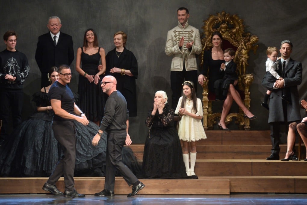 Dolce and Gabbana take to the stage following the “family portrait” finale of their autumn-winter 2015 menswear show, in Milan, Italy, in January. Photos: AFP; handouts
