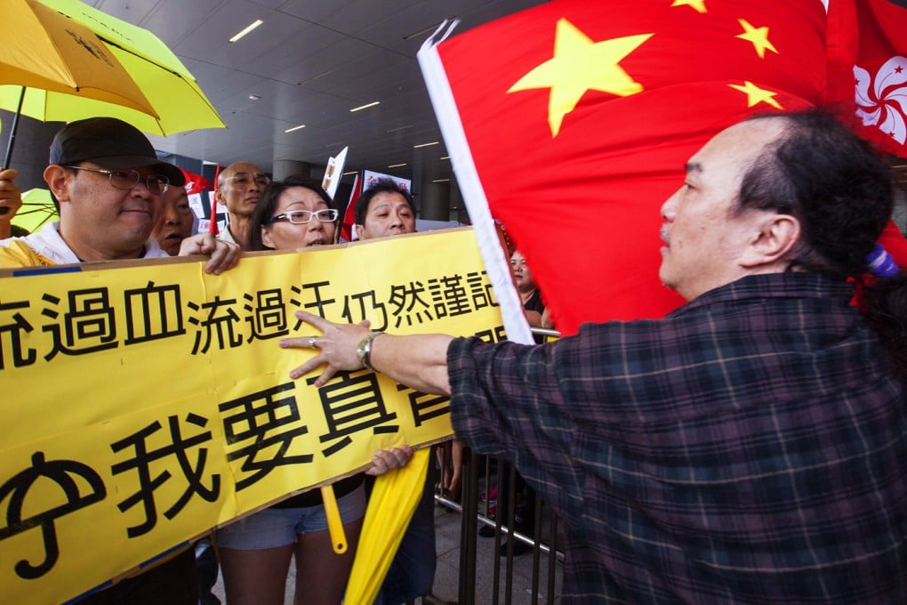 Supporters of the Hong Kong government's political reform package waving Chinese national and Hong Kong regional flags scuffle and exchange verbal abuse with protesters waving yellow umbrellas and banners opposing the Hong Kong government's proposal, Hong Kong on April 22, 2015. Photo: EPA