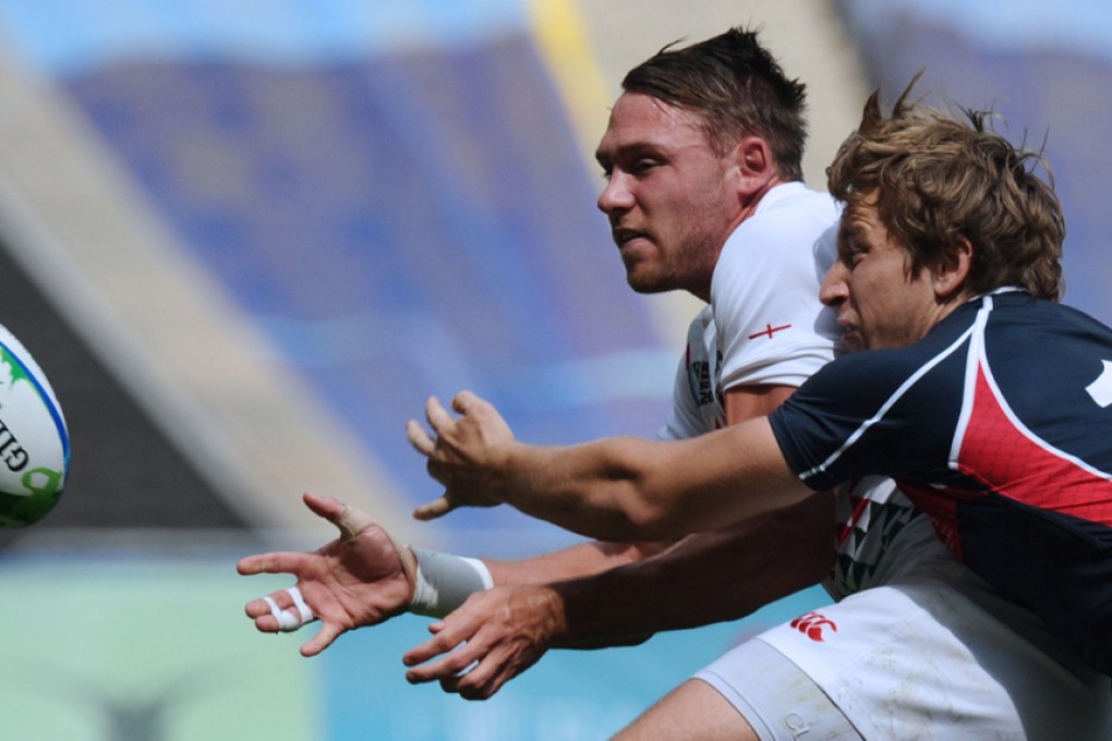 Christian Lewis-Pratt of England offloads as Hong Kong’s Tom McQueen makes a tackle during the preliminary stages of the 2013 Rugby World Cup Sevens in Moscow. World Rugby announced Thursday that the 2018 edition will take place in San Francisco. Photos: AFP