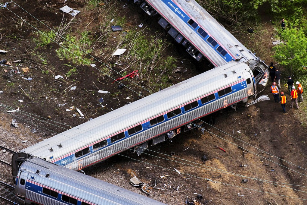 Emergency workers and Amtrak personnel inspect a derailed Amtrak train in Philadelphia, Pennsylvania. Photo: Reuters