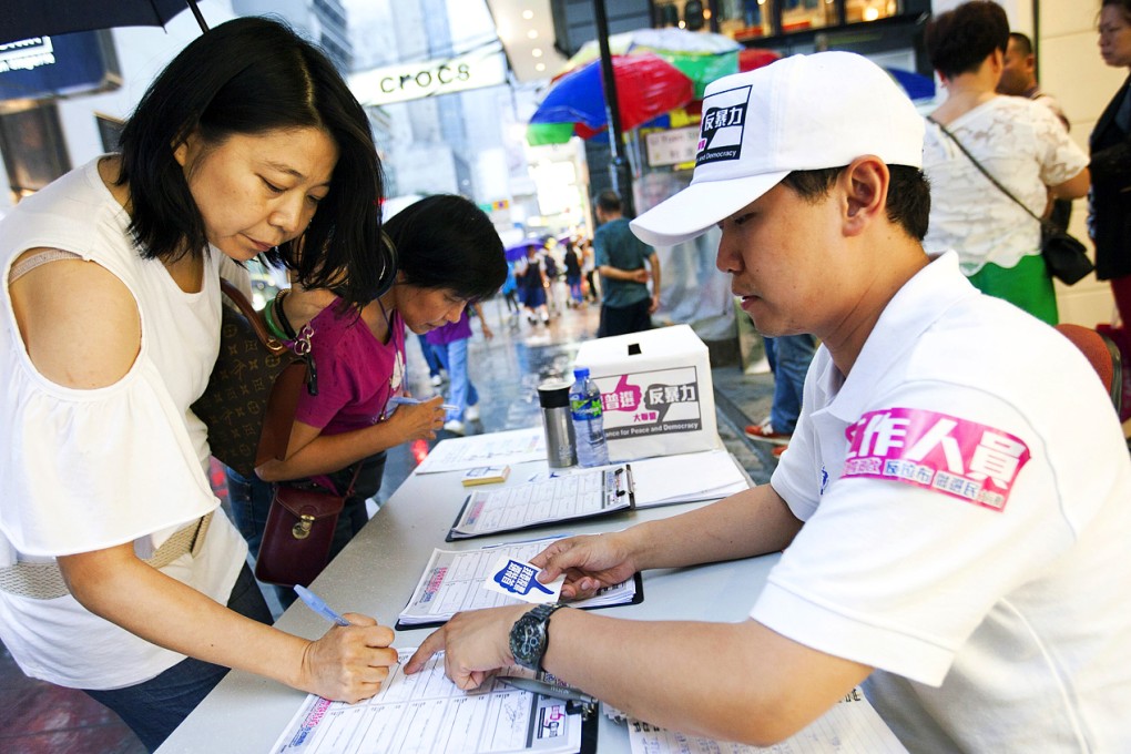Campaigners collect signatures in favour of political reform. Photo: EPA