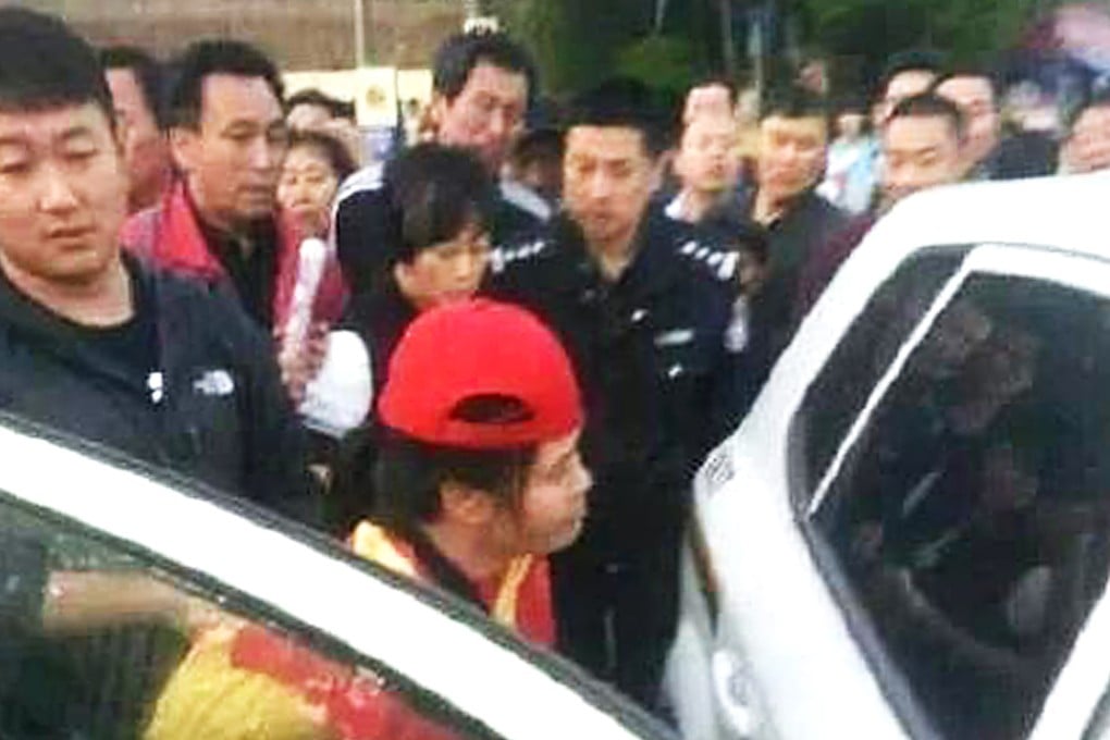 The traffic warden is led away by police. Photo: SCMP Pictures