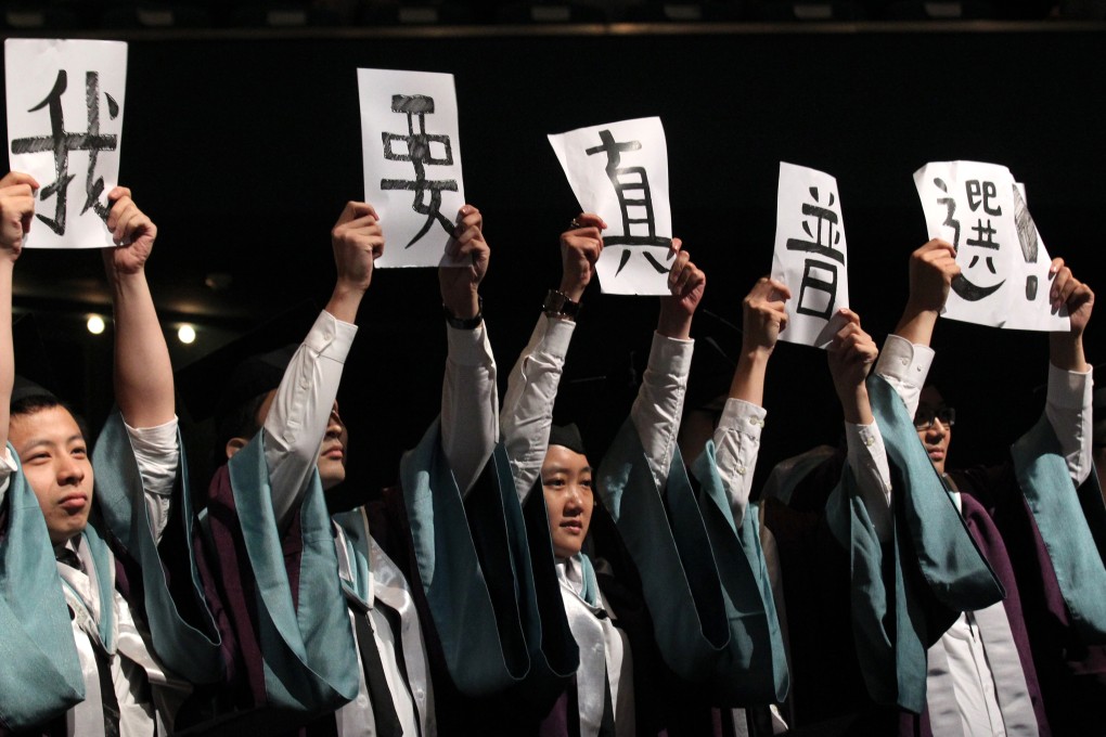 Students from the Academy for Performing Arts hold placards that say "I want genuine universal suffrage". Photo: Dickson Lee