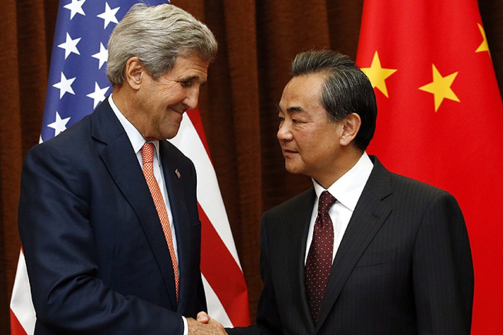 US Secretary of State John Kerry shakes hands with Chinese Foreign Minister Wang Yi prior to their meeting in Beijing on Saturday. Photo: EPA
