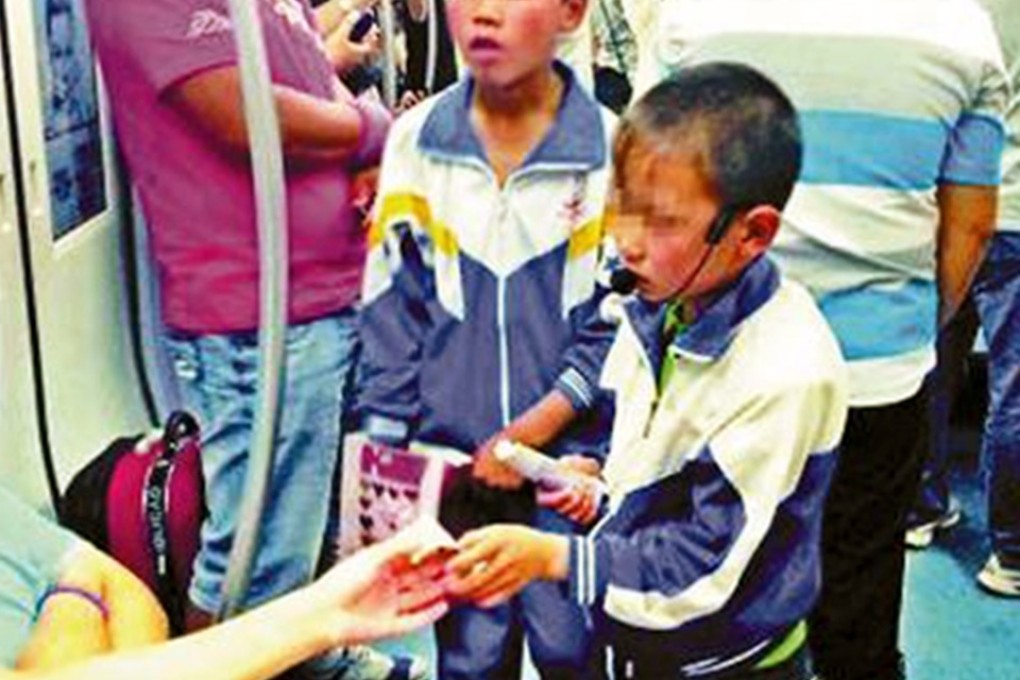 Children ask for money on a subway. Beijing is cracking down on panhandling inside the trains and stations. Photo: SCMP Pictures