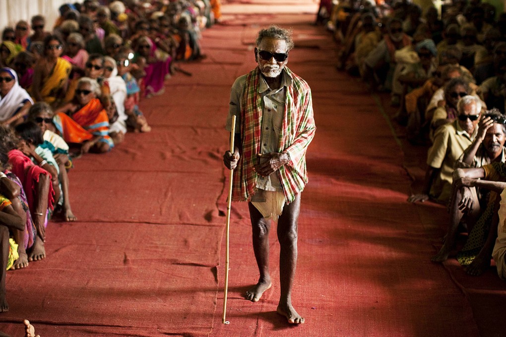 Indian tribal villagers wait wear protective glasses as they wait in a post-operative care area after cataract surgeries in Jagdalpur, Chattisgarh, India. Photo: AP