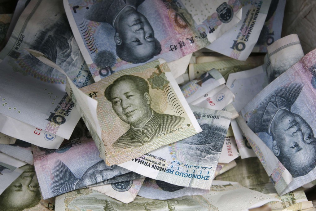 China's yuan bank notes are seen in a vendors' cash box as the country's central bank set the midprice of the currency at its highest in 15 months. Photo: Reuters
