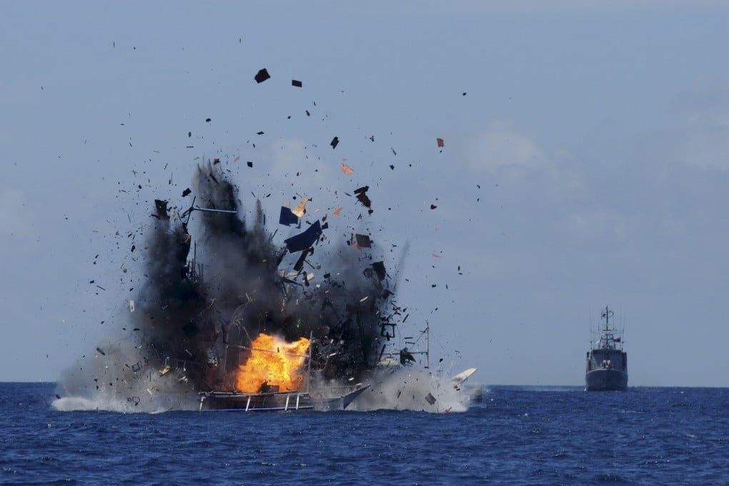 The Indonesian navy scuttles a foreign fishing vessel caught fishing illegally in Indonesian waters near Bitung, North Sulawesi, on Wednesday. Photo: Reuters