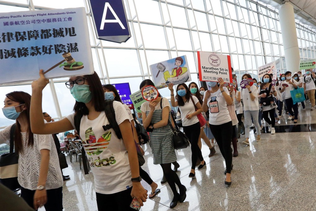 Cathay Pacific flight attendants continued their march and sit-in protest at Chek Lap Kok airport yesterday. The dispute revolves around pay, allowances and legal protection. Photo: Felix Wong