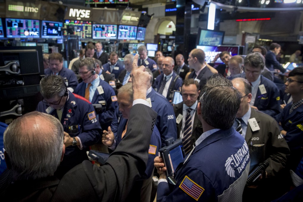 A gaggle of traders in New York. Corporate bond fund investors react badly when losing money and can cause trouble when a selloff in illiquid markets start. Photo: Reuters