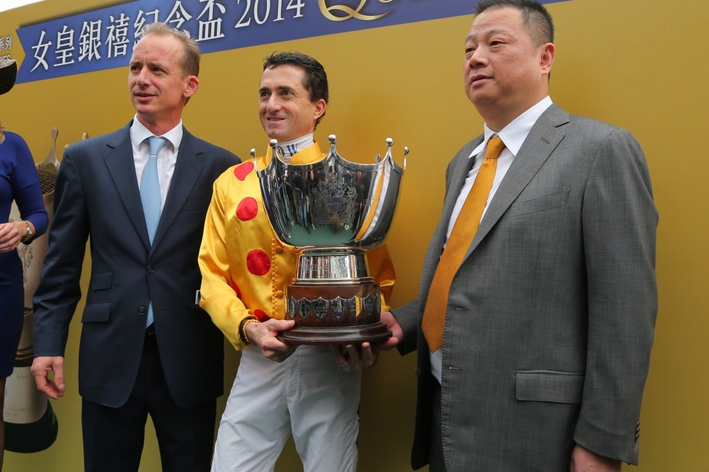 Goldin group chief Pan Sutong (right) poses at the Queen's Silver Jubilee Cup in Hong Kong. Shares of his two companies tumbled on Thursday as the knock-on effect of selling Hanergy apparently hit the two firms as well. Photo: Kenneth Chan