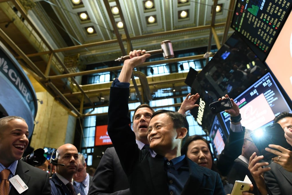 Alibaba founder Jack Ma Yun holds up a gravel before ringing a bell to open trading on the floor at the New York Stock Exchange in New York in September 2014. Photo: AFP