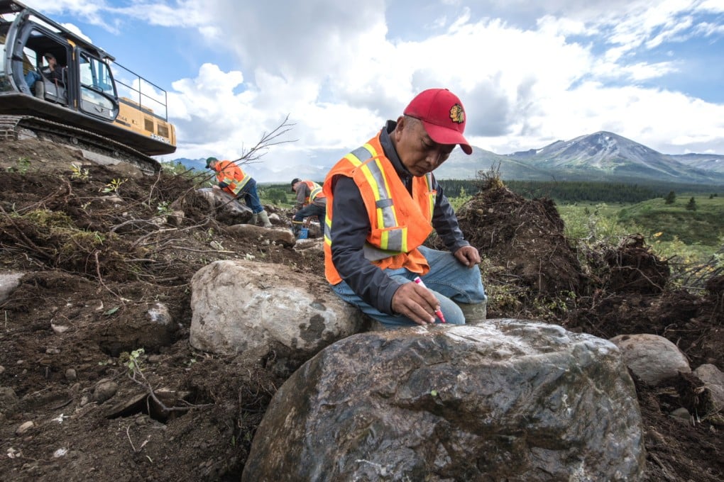 Alan Qiao, CEO of Dease Lake Jade Mines, inspects a boulder at the firm’s Wolverine mine site in far northern British Columbia. Photo: SCMP Picture/Handout