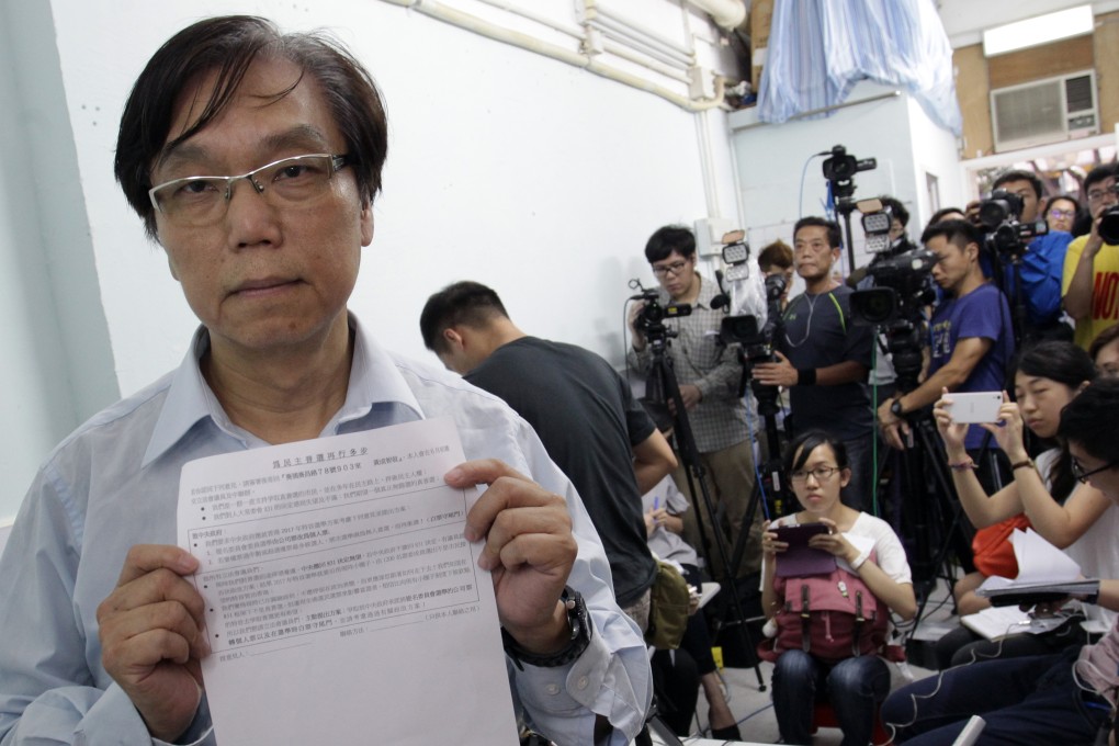 Democrat Nelson Wong Sing-chi displays the form that will be used in his signature campaign endorsing political reforms, but with two main concessions from Beijing. Photo: Dickson Lee