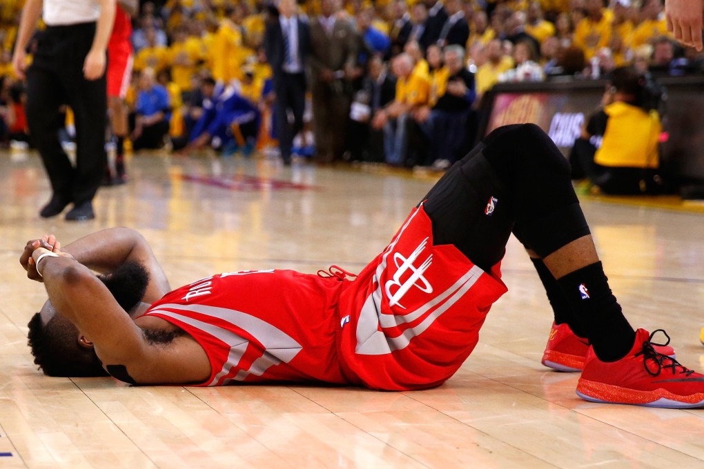 James Harden of the Houston Rockets lies slumped on the court after being denied a game-winning shot against the Golden State Warriors in game two of the Western Conference finals. Photo: AFP