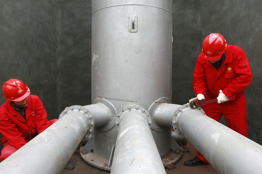 Labourers work at a PetroChina refinery in Suining in Sichuan. Photo: Reuters