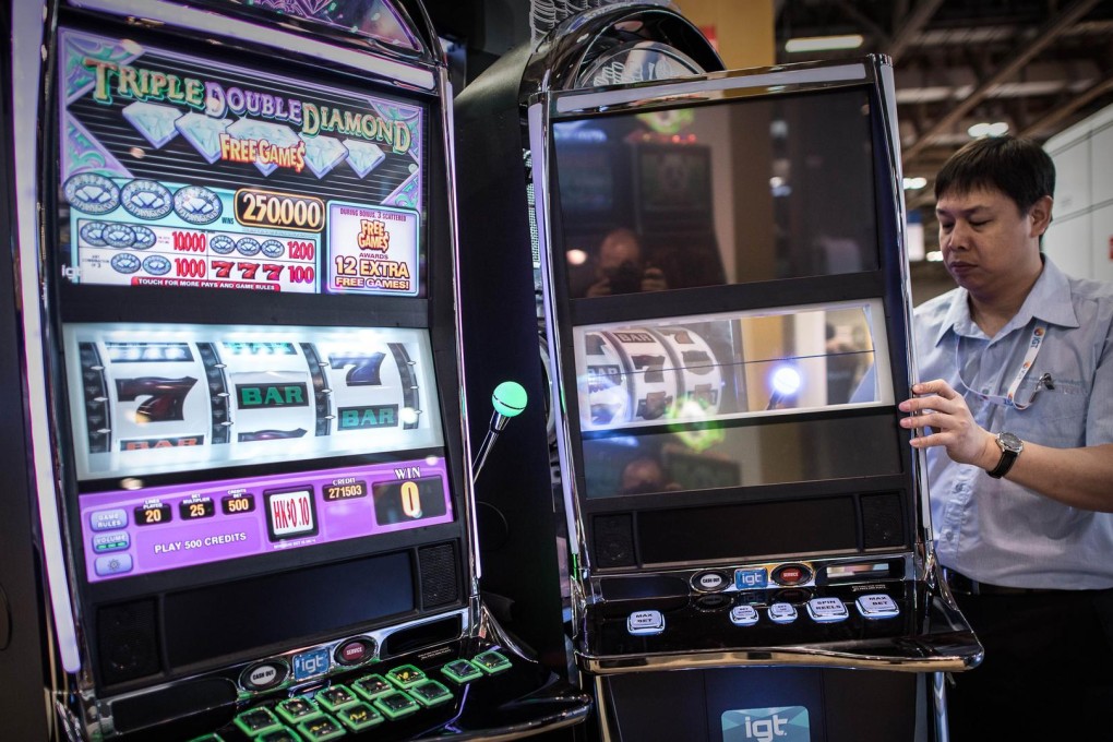 A technician checks slot machines at The Venetian in Macau. The machines have become dominant in casinos over the years. Photo: AFP